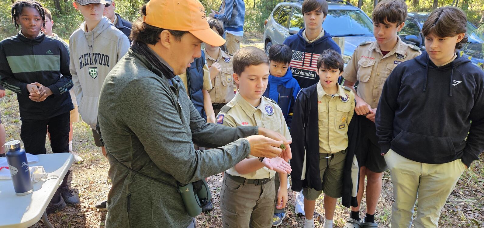 Beidler Forest Center Director Matt Johnson demonstrates proper bird band techniques to a group of Boy Scouts and other interested members of the public