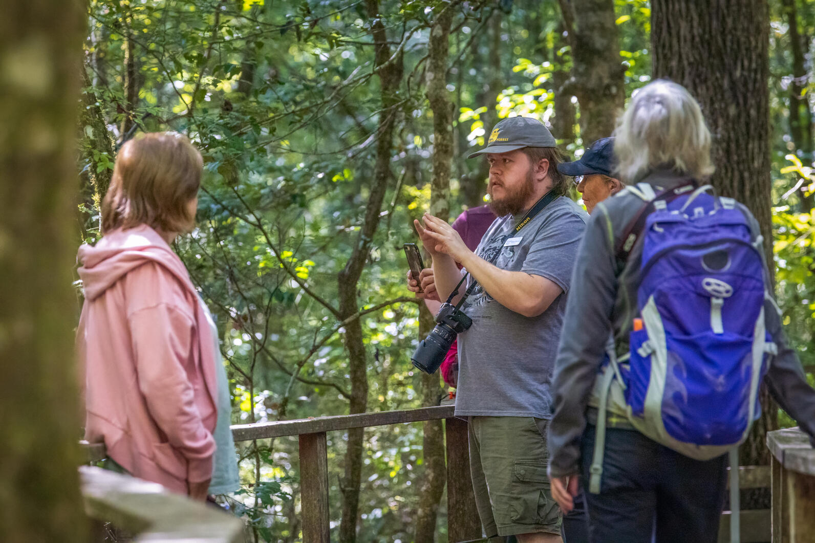 Staff naturalist Ryan Watson leads guests and volunteers on a guided walk through the swamp.