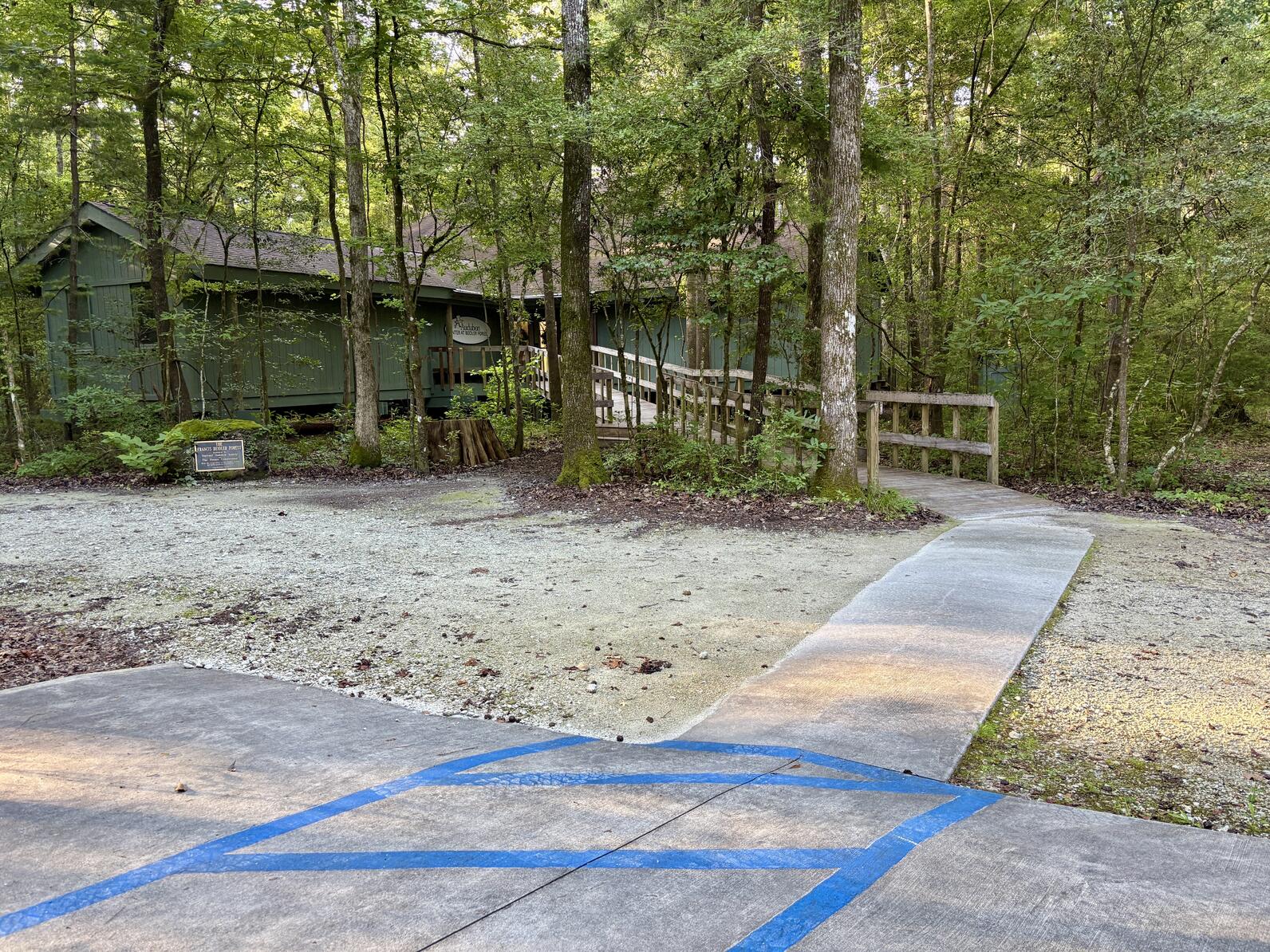 The Beidler Forest visitor center is accessible by a long ramp with a 4.8 degree incline. While most of the parking lot is gravel, the handicap parking is on a cement platform with a cement path leading to the start of the ramp.