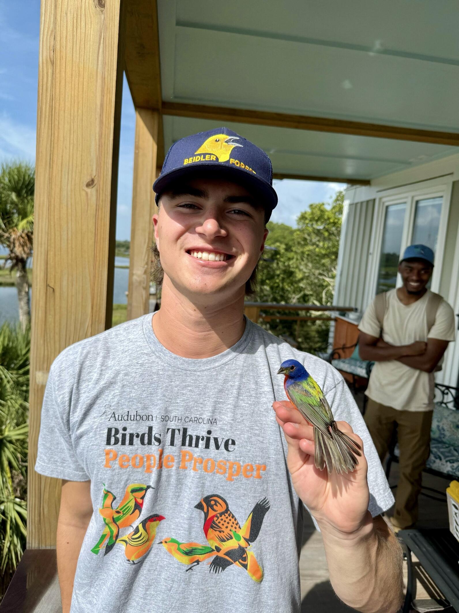 jacob holds a brightly colored painted bunting in his hand jacob holds a brightly colored painted bunting in his hand